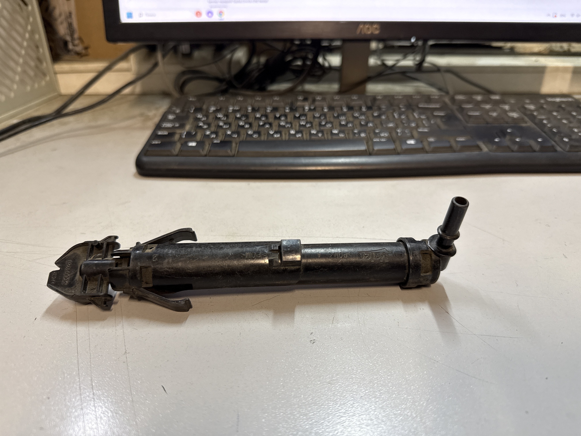 Форсунка омывателя фары левая Opel Zafira C